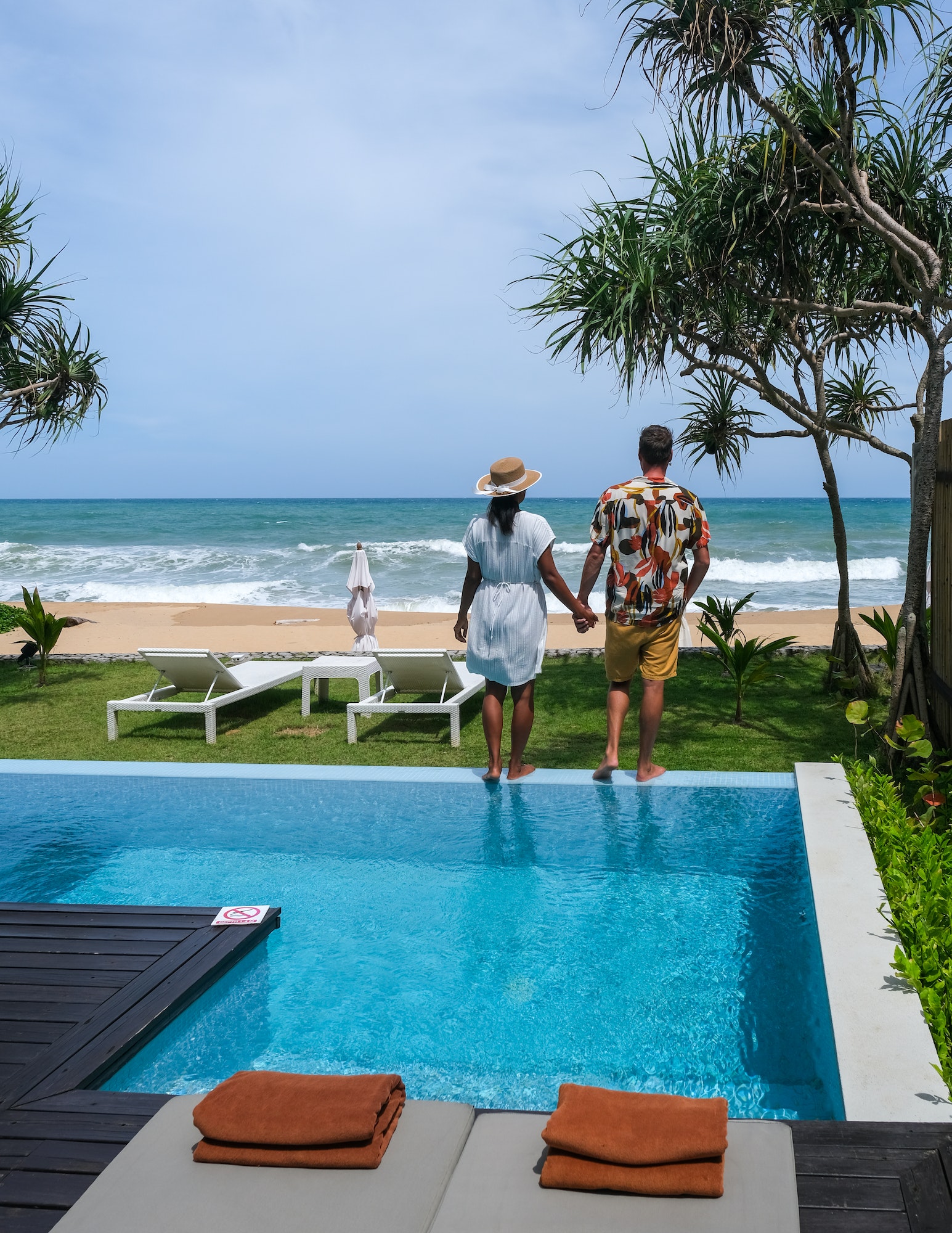 couple men and women on a luxury vacation at a pool villa