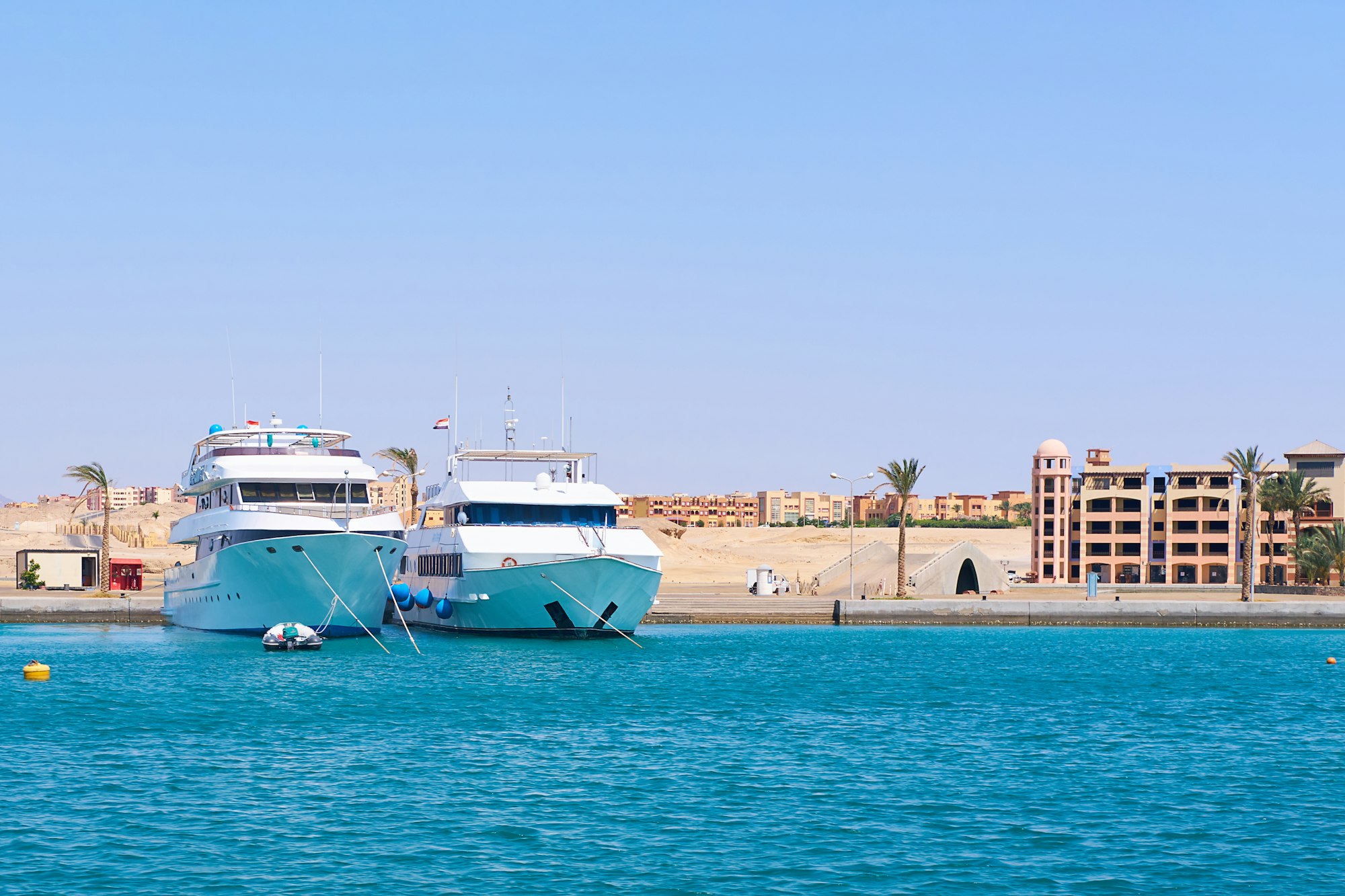 Luxury Yachts Docked at Tropical Resort Marina, Clear Blue Sea and Sky