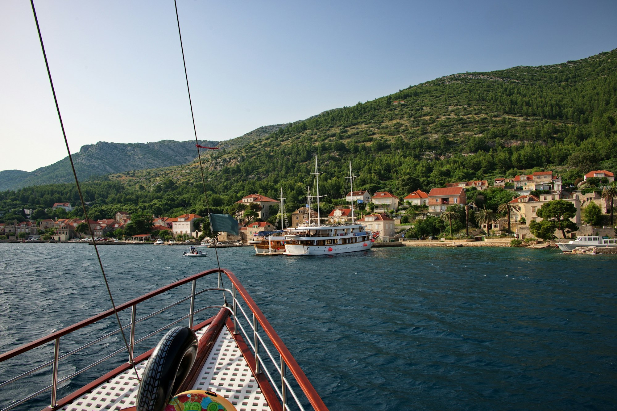 Railing on cruise sailing boat entering the Mediterranean town