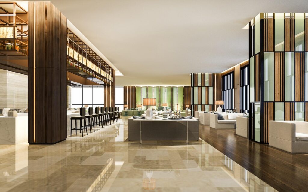 The expansive, modern lobby of one of the Marriott hotels featuring polished marble floors, a stylish bar area with high stools, and contemporary lounge seating.