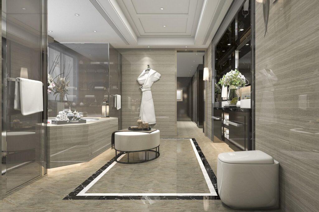 Spacious luxury bathroom with marble walls and floors, walk-in glass shower, and elegant vanity, similar to high-end resort business center accommodations.