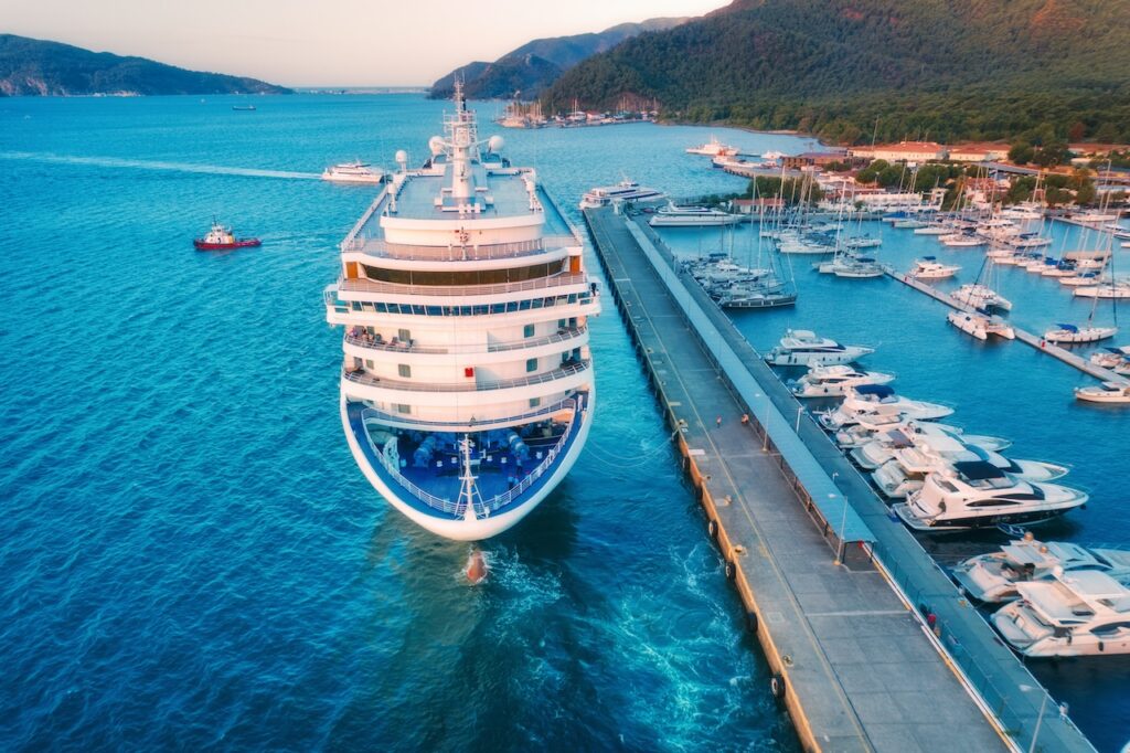 Panoramic view of a British Virgin Islands bay, showcasing anchored yachts and lush hills, perfect for a BVI all-inclusive, adults-only escape vacation.