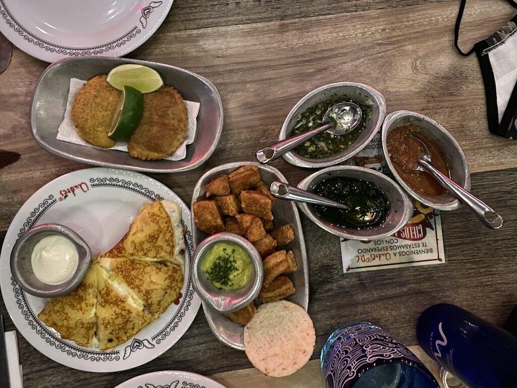 An overhead view of a table spread with Mexican appetizers and dips, a vibrant meal to enjoy before heading to the international airport.