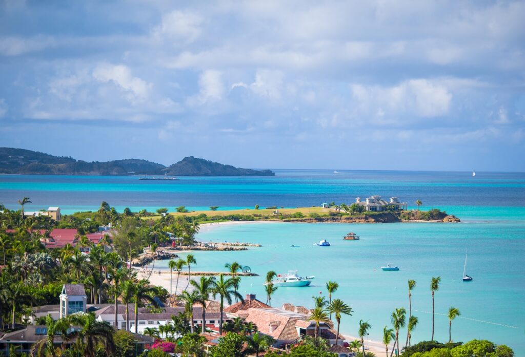 Aerial view of a secluded tropical island coastline with turquoise ocean and luxury villas, perfect for a high-end British Virgin Islands all-inclusive adults-only escape.