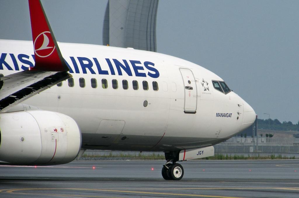 Commercial airplane on a runway, ideal for adding stopovers to your flight.