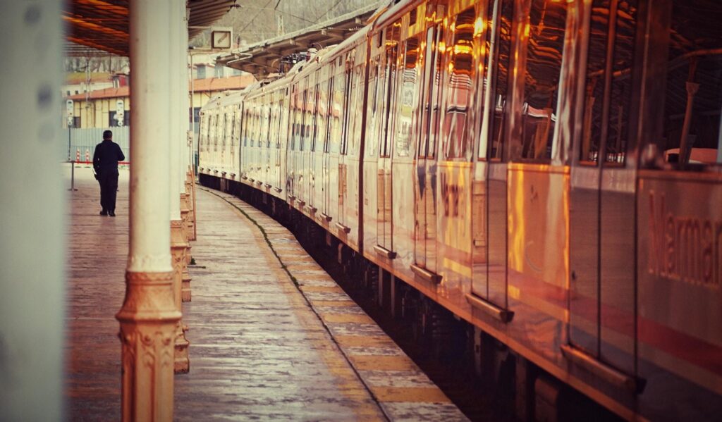 A gold-toned train at a station platform, reflecting the epitome of luxury for high-end rail travel.