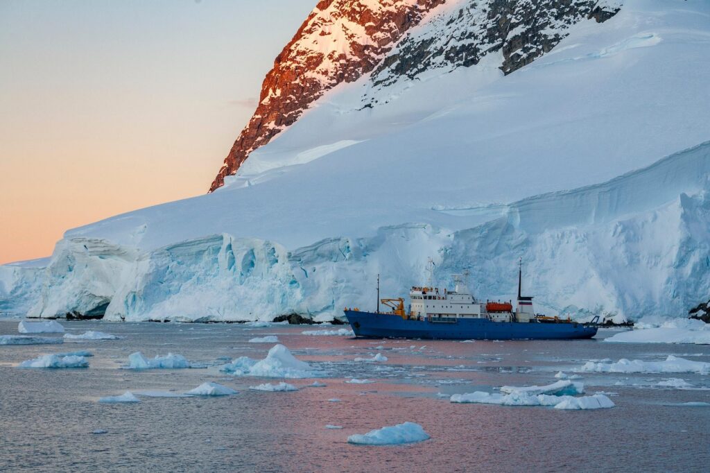 Expedition ship navigating icebergs on Antarctic cruises.