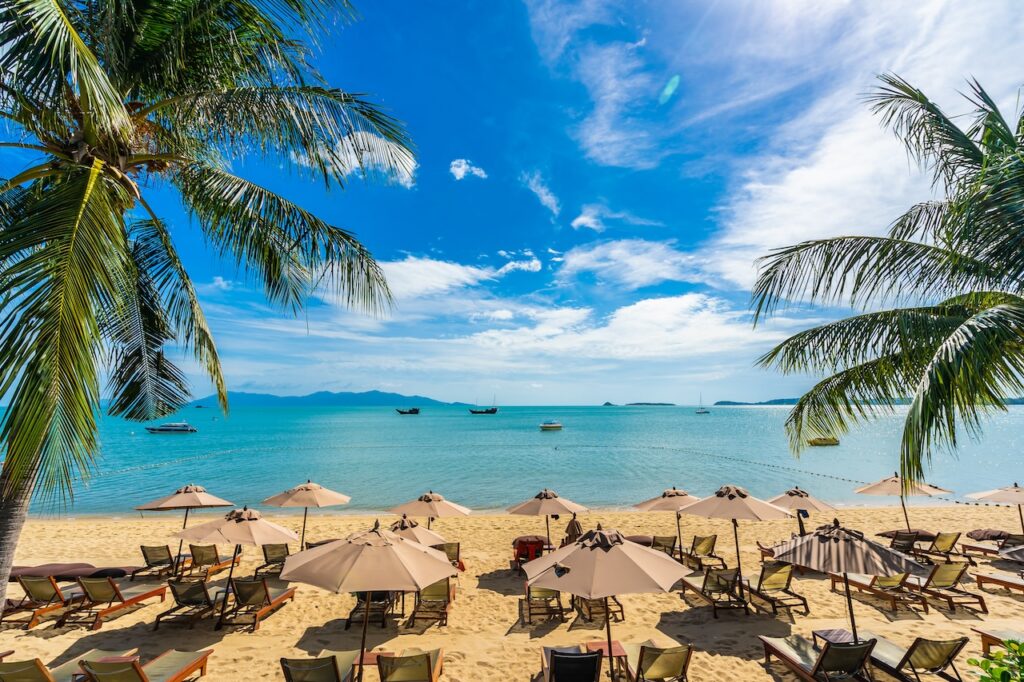 Panoramic ocean view of a stunning Caribbean bay with turquoise water, luxury villas, and tropical coastline, perfect for a high-end beach vacation.