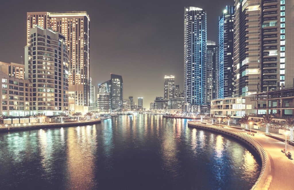 A glowing night skyline featuring the Burj Khalifa and illuminated skyscrapers, capturing the vibrant atmosphere for travelers who plan to visit Dubai.