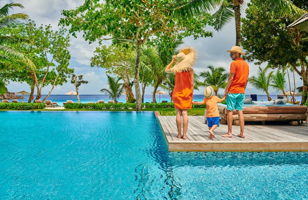 Couple enjoying drinks and snacks in a luxury ocean-view suite, emphasizing the high-end comfort of an adults-only, all-inclusive British Virgin Islands escape.
