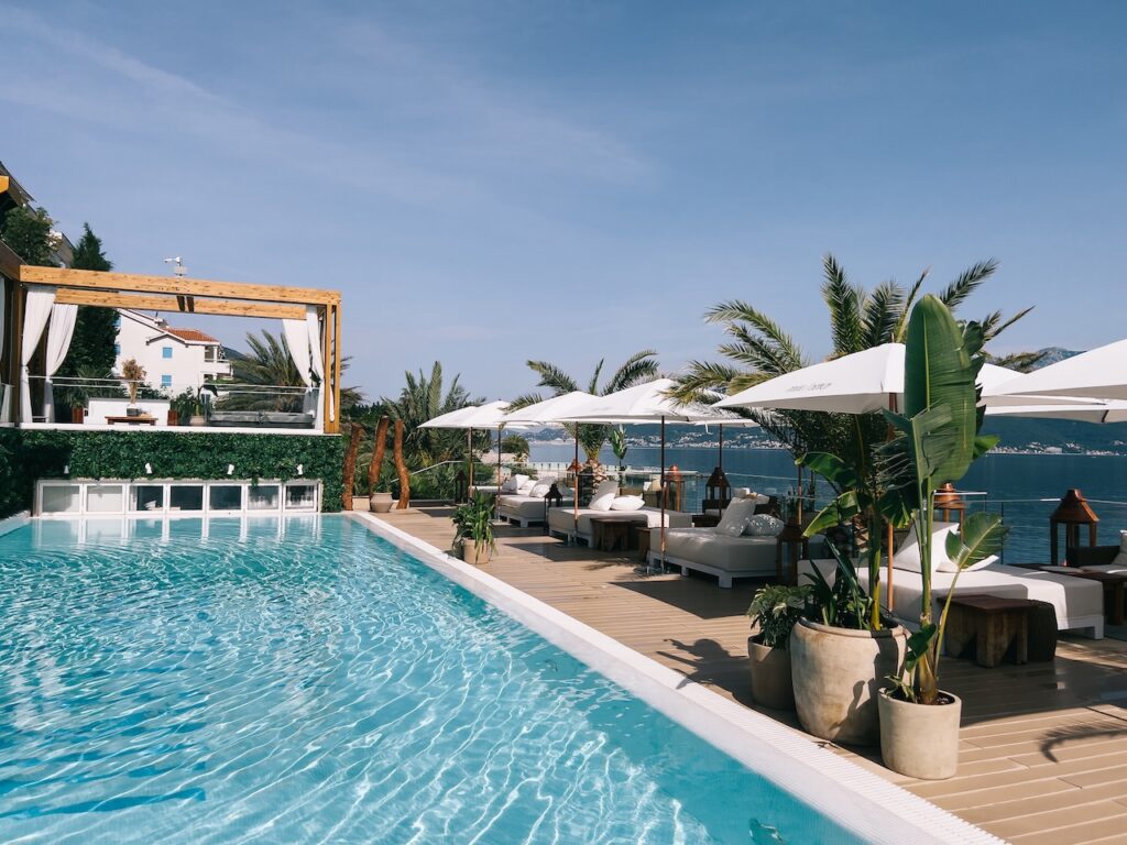 Guest relaxing on a private waterfront daybed with serene ocean views, symbolizing the ultimate comfort and exclusive luxury escape at the Hotel Christopher.