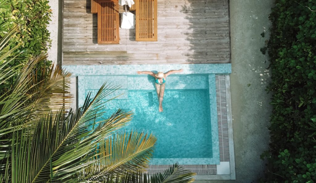 Woman relaxing in a private plunge pool, symbolizing the exclusive luxury of an all-inclusive, adults-only British Virgin Islands escape resort.