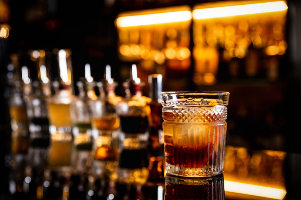 A classic cocktail with a large ice cube served in a crystal rocks glass at the King Cole Bar.