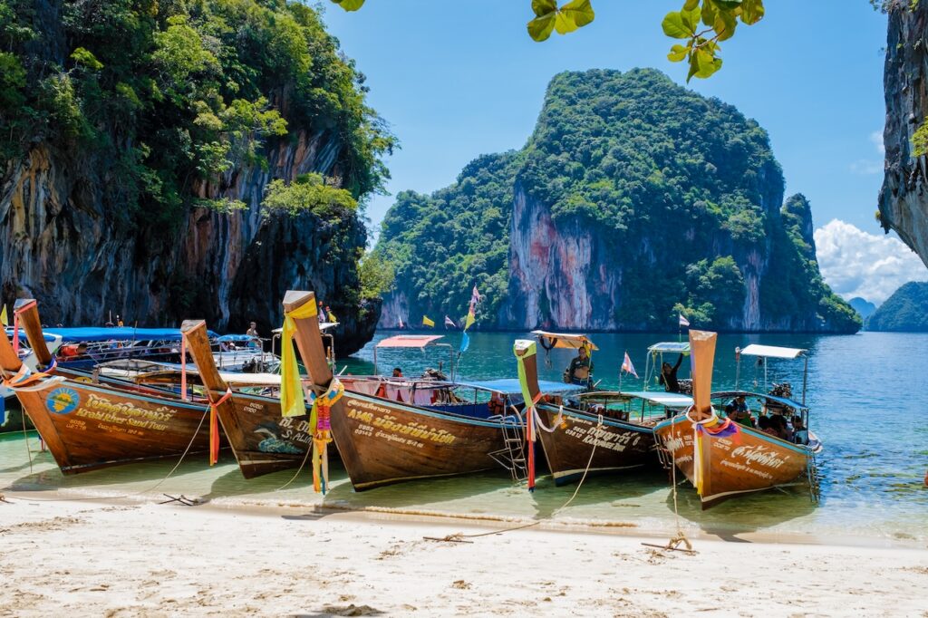 View from a boat entering a stunning cove surrounded by limestone karsts, highlighting an unforgettable sea and island exploration adventure.
