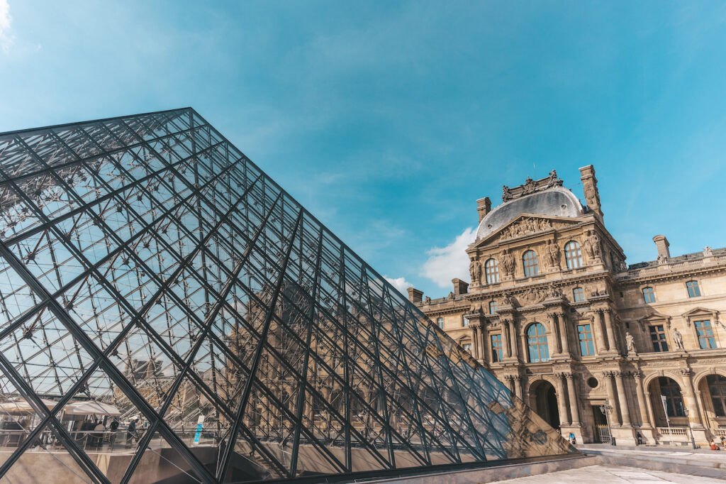 The glass and metal pyramid marks the main entrance to the Louvre Museum in Paris.