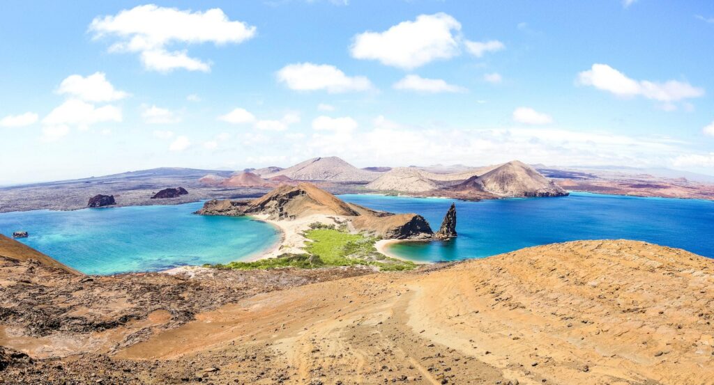 Panoramic view of the volcanic landscape and turquoise bays of Bartolomé Island, a highlights of the Galápagos Islands.