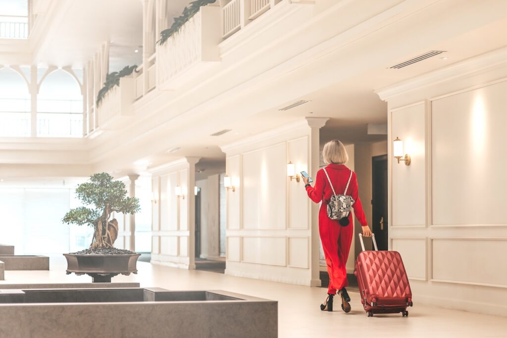 Guest walking through a bright, luxurious Hyatt Privé lobby, representing the elegant design of a top property.