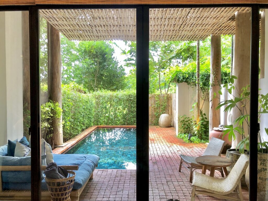Private plunge pool in a lush, green tropical garden courtyard, highlighting luxurious and secluded accommodations at an exotic resort or villa.