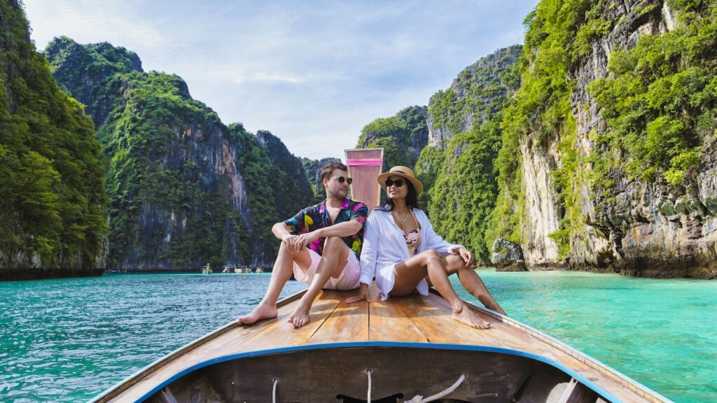 Traveler enjoying a fun longtail boat ride, illustrating the perfect blend of water adventure and luxurious setting.