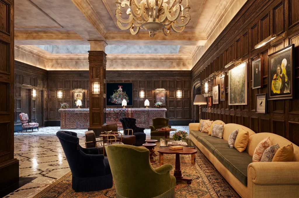 A luxurious hotel lobby with dark wood paneling, velvet armchairs, and a grand chandelier, offering exclusive benefits for guests booking through Hyatt Privé.