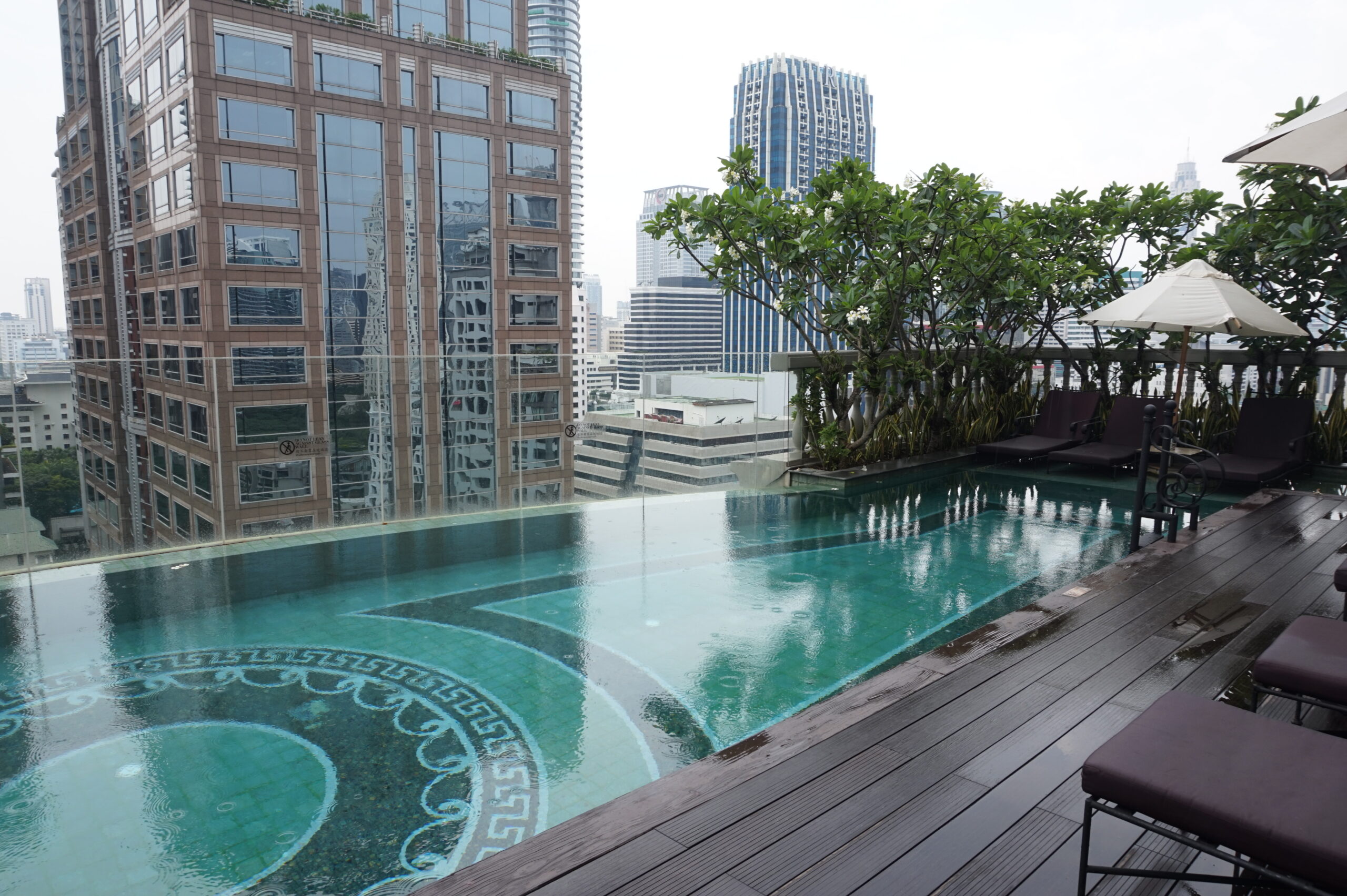 Rooftop infinity pool overlooking the city skyline, capturing the rare places Scott & Thomas curates for every journey