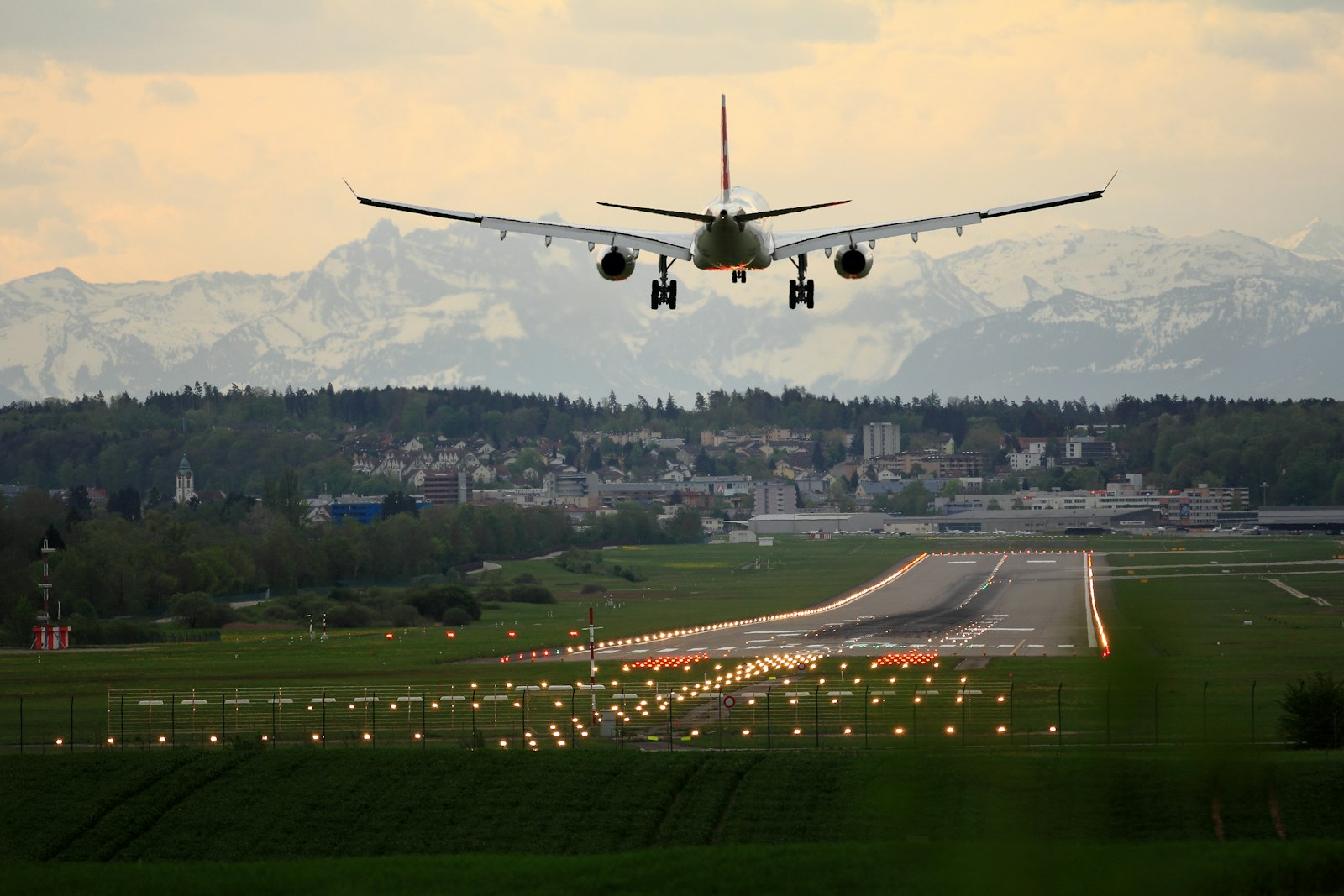 A commercial airplane landing at an airport, a common sight when traveling between continents via a major airline alliance.