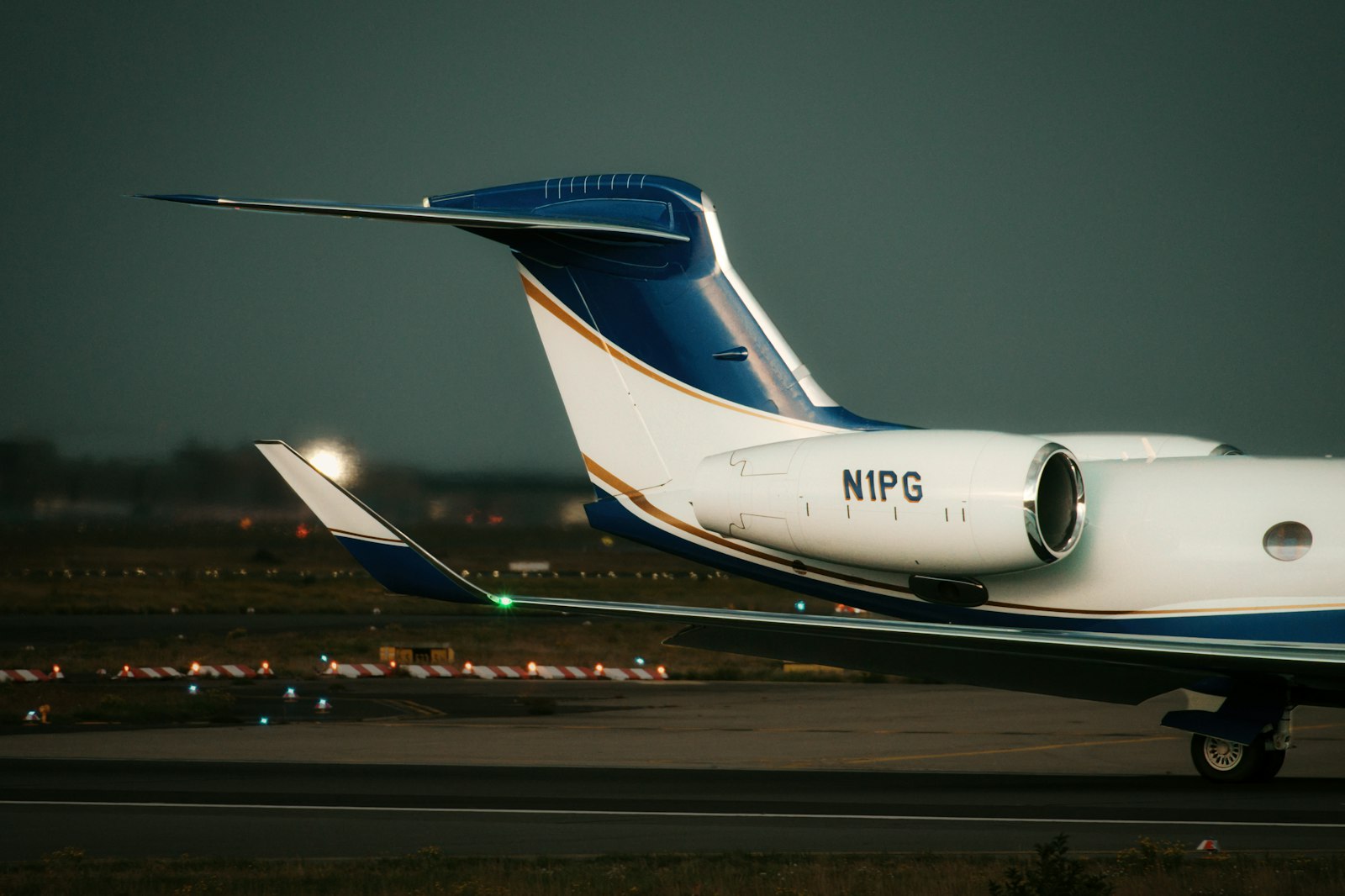 A private jet on the tarmac at dusk.