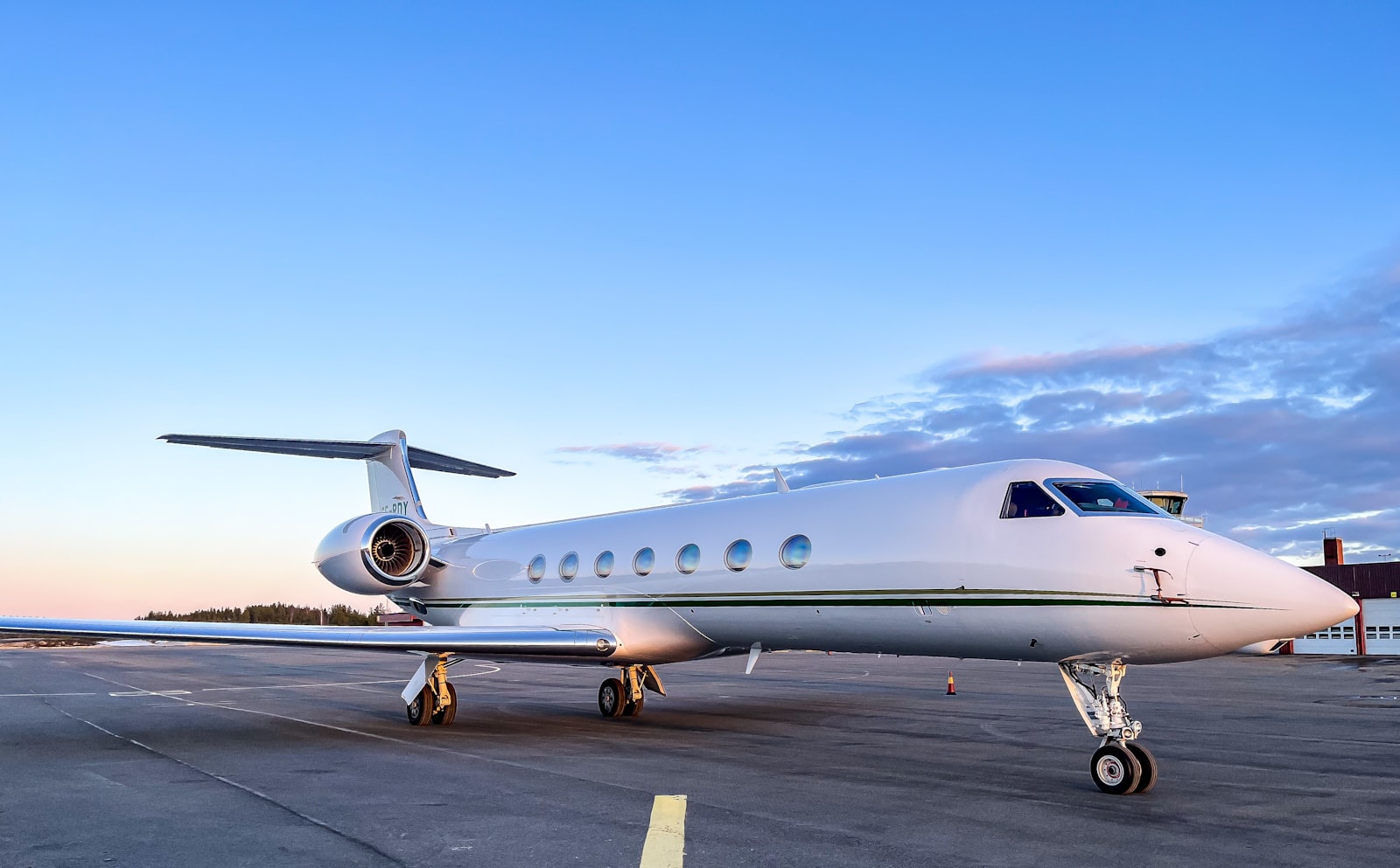 A private jet parked on the tarmac, ready for boarding.